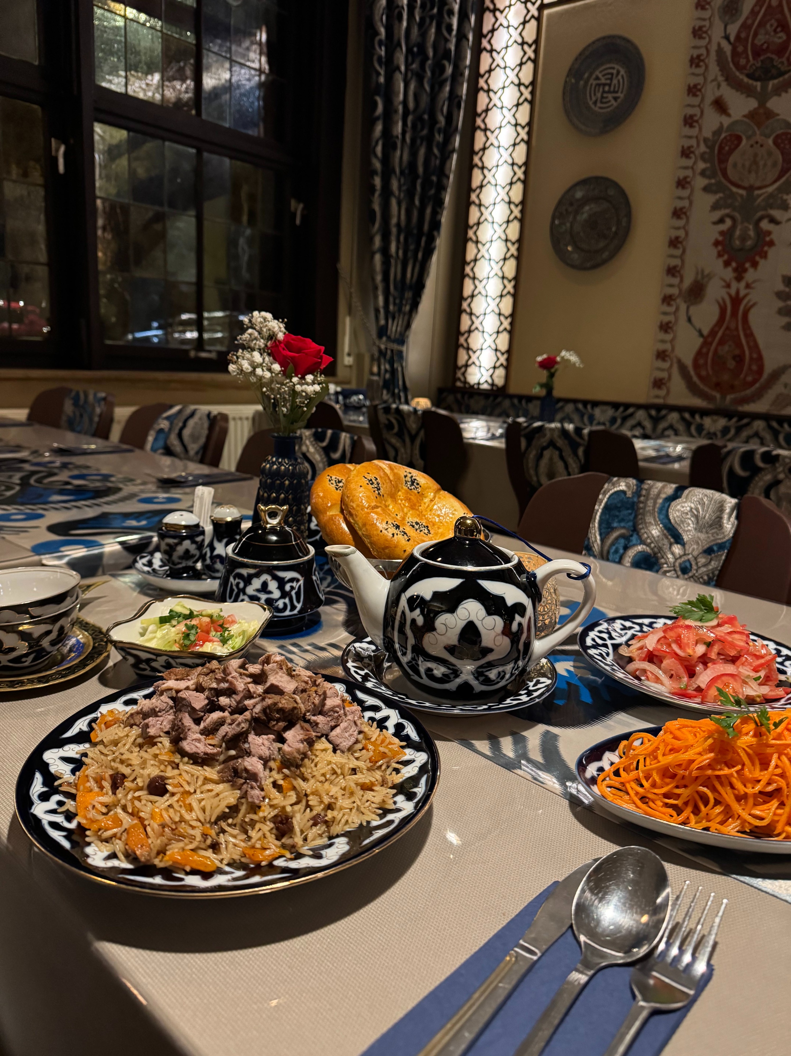 Cozy interior of CARAVAN Uzbek Restaurant Frankfurt with traditional Central Asian carpets and warm atmosphere